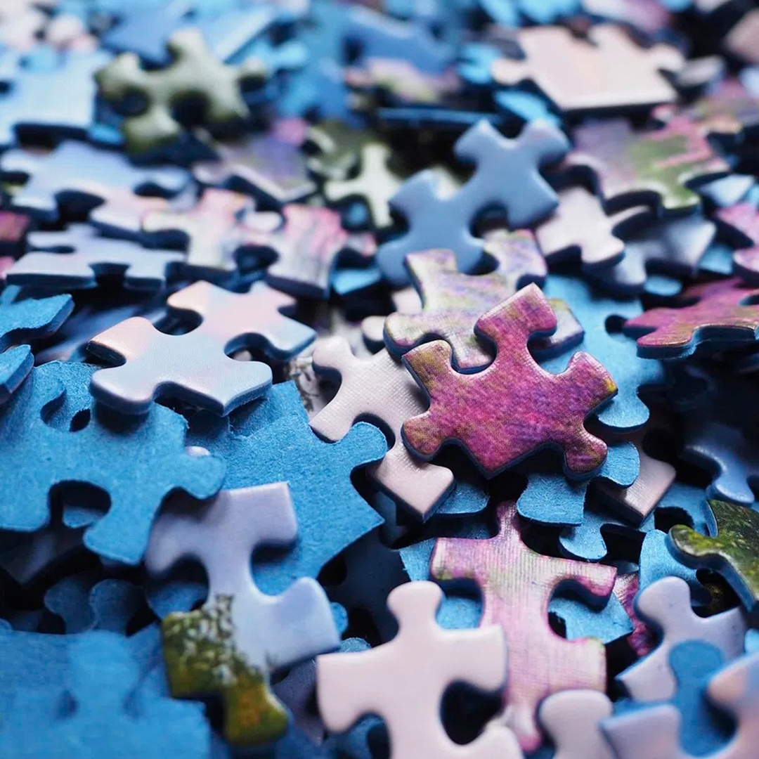 Pile of puzzle pieces in shades of blue and purple